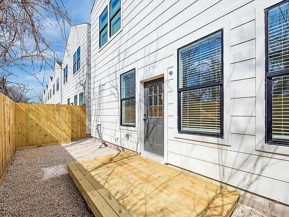Side elevation with a new wood deck and a board privacy fence, Bianco Lane, Houston TX 77091