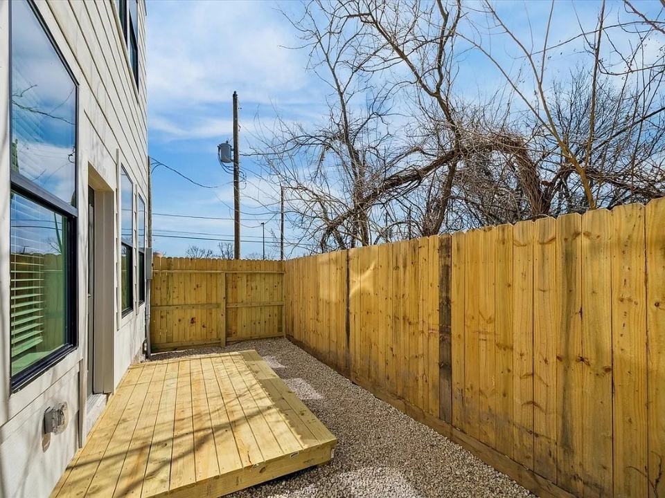 Fenced rear yard with a wood deck off the back door, Bianco Lane, Houston TX 77091