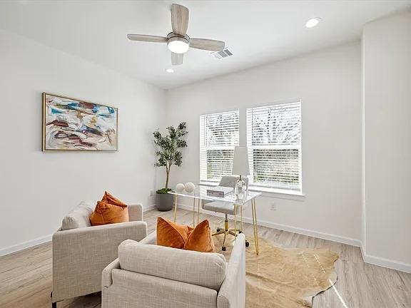Living area with armchairs set against a window wall, Bianco Lane, Houston TX 77091