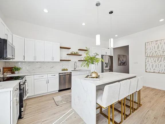 Kitchen island with pendant lights and bar seating, Bianco Lane, Houston TX 77091