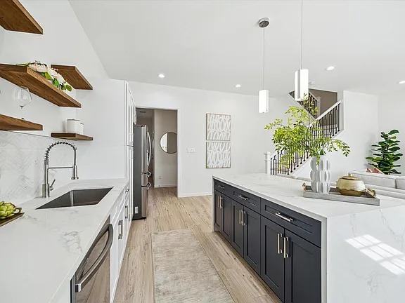 Kitchen run with dark lower cabinets and an undermount sink, Bianco Lane, Houston TX 77091