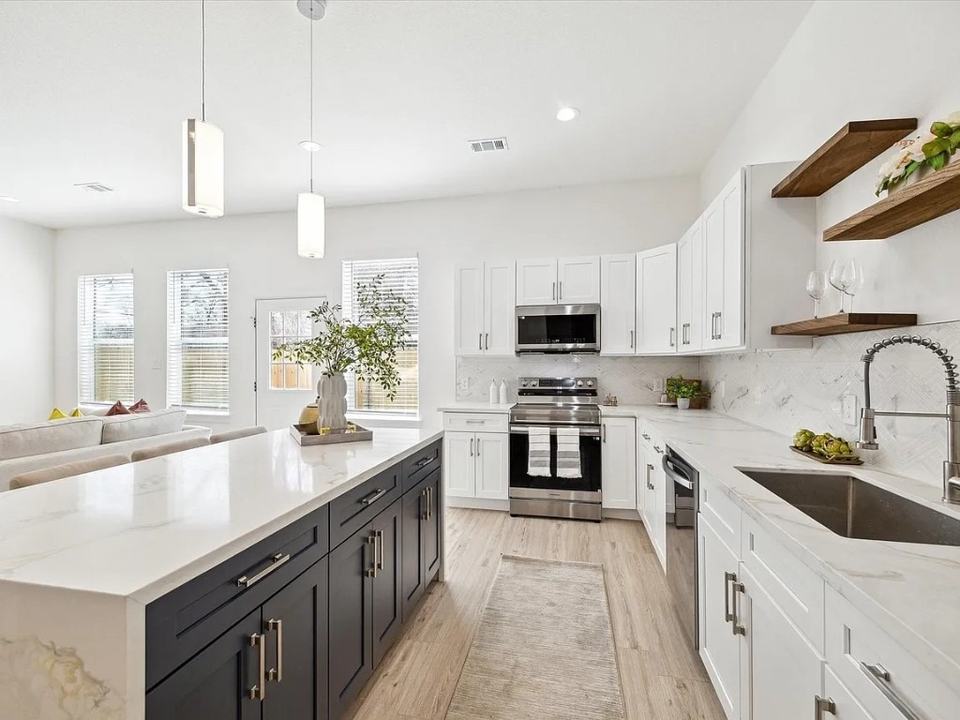 Kitchen with open timber shelving beside the range and a window over the sink, Bianco Lane, Houston TX 77091