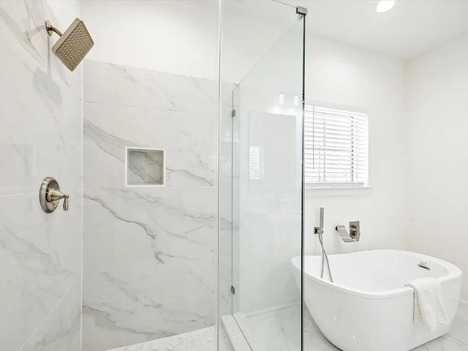 Primary bathroom with a marble walk-in shower and a freestanding tub, Bianco Lane, Houston TX 77091