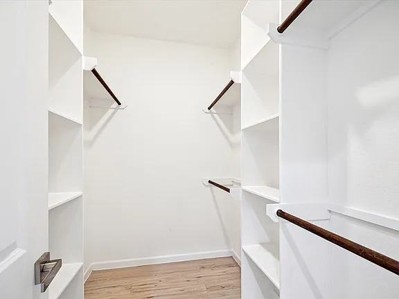 Primary closet with white built-in shelving, Bianco Lane, Houston TX 77091