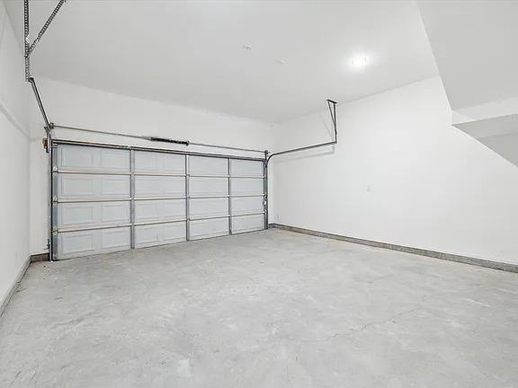 Two-car garage interior with a finished slab, Bianco Lane, Houston TX 77091