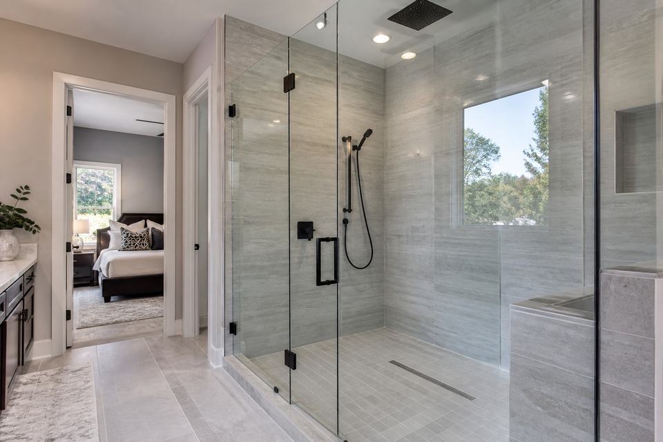 Frameless walk-in shower with matte black hardware