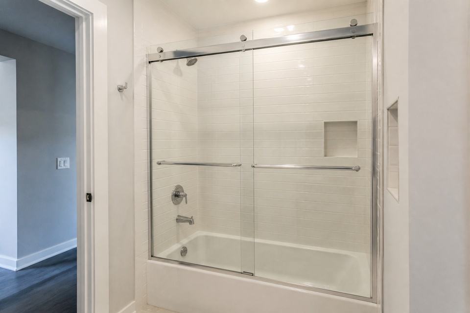 Sliding glass tub enclosure with chrome hardware