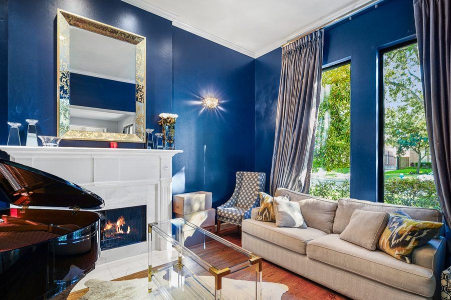 Living room with tall windows beside the fireplace, Houston TX 77025