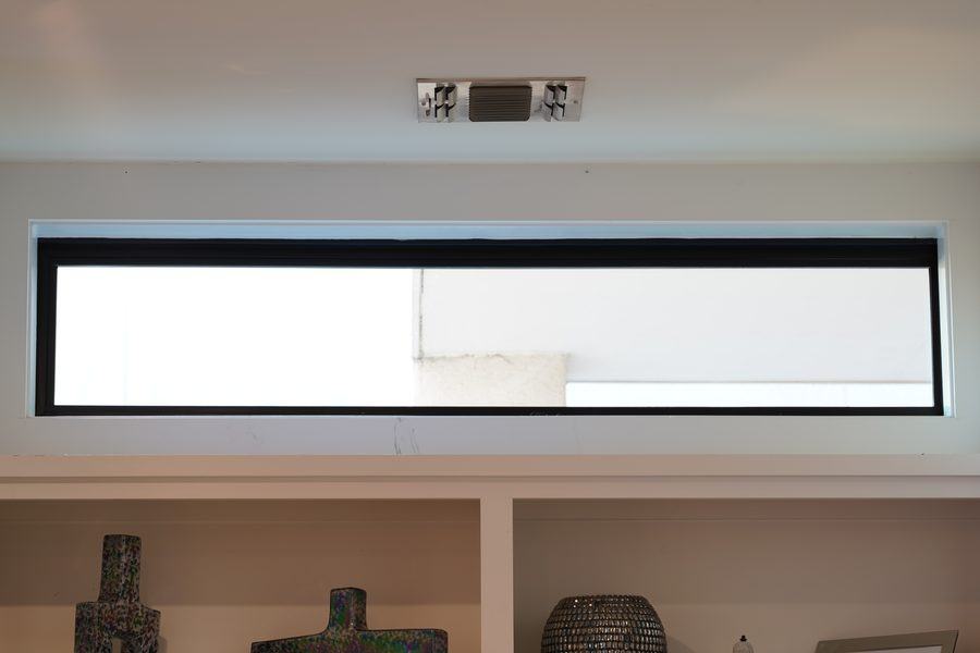 High clerestory strip window above built-in shelving, Houston TX 77025