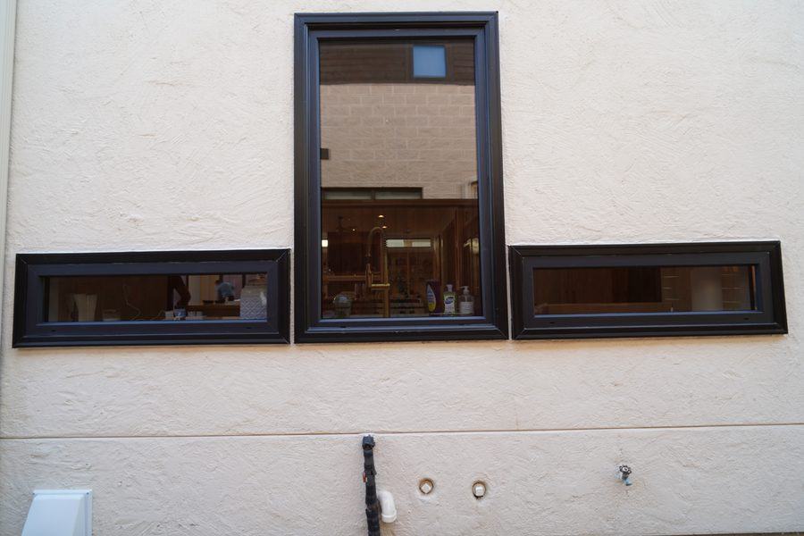 A tall window between two strip windows on the side wall, Houston TX 77025