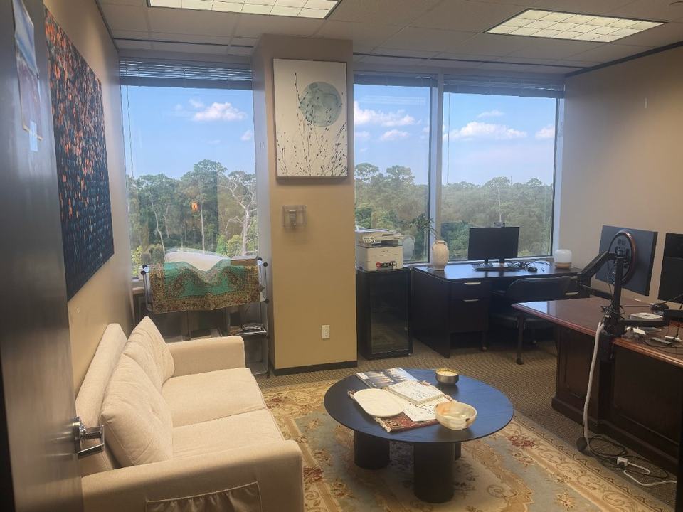 Medai Digital executive office in Houston with workstations, a client sitting area, and windows overlooking Memorial Park