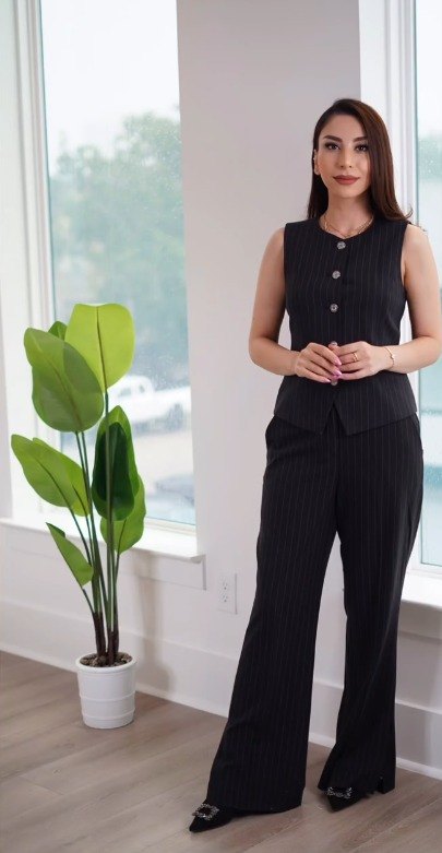 Maryam Estate, real estate agent at Kiani Realty, standing beside a window in a residential interior