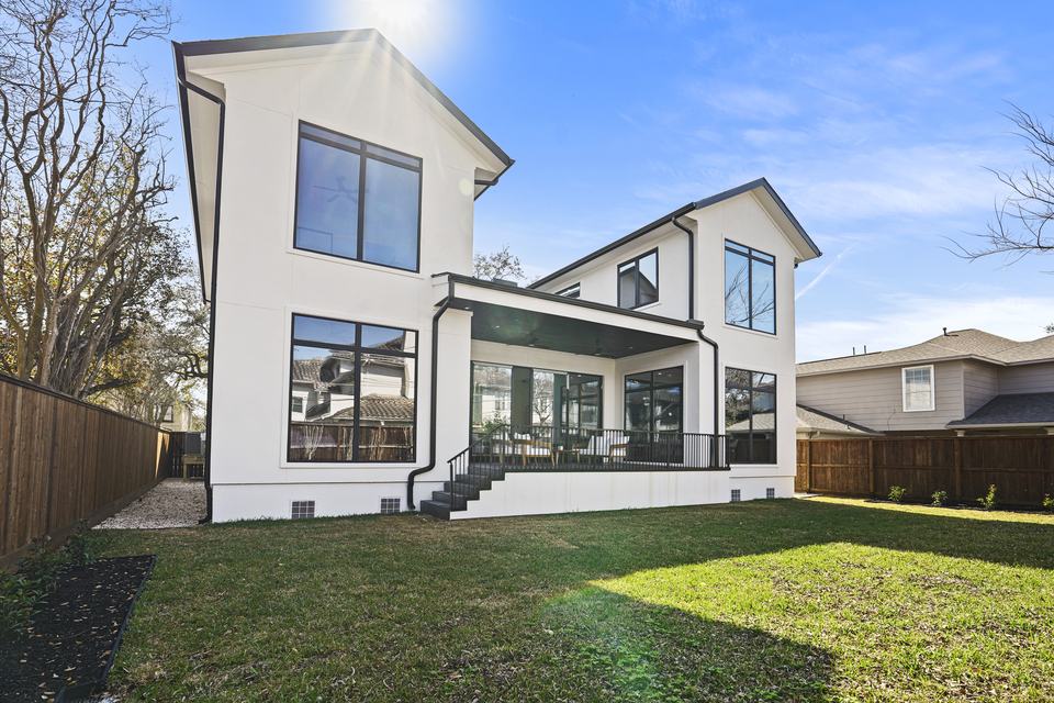 Brick home with new windows facing a lawn, Royal Windoor installation in Houston