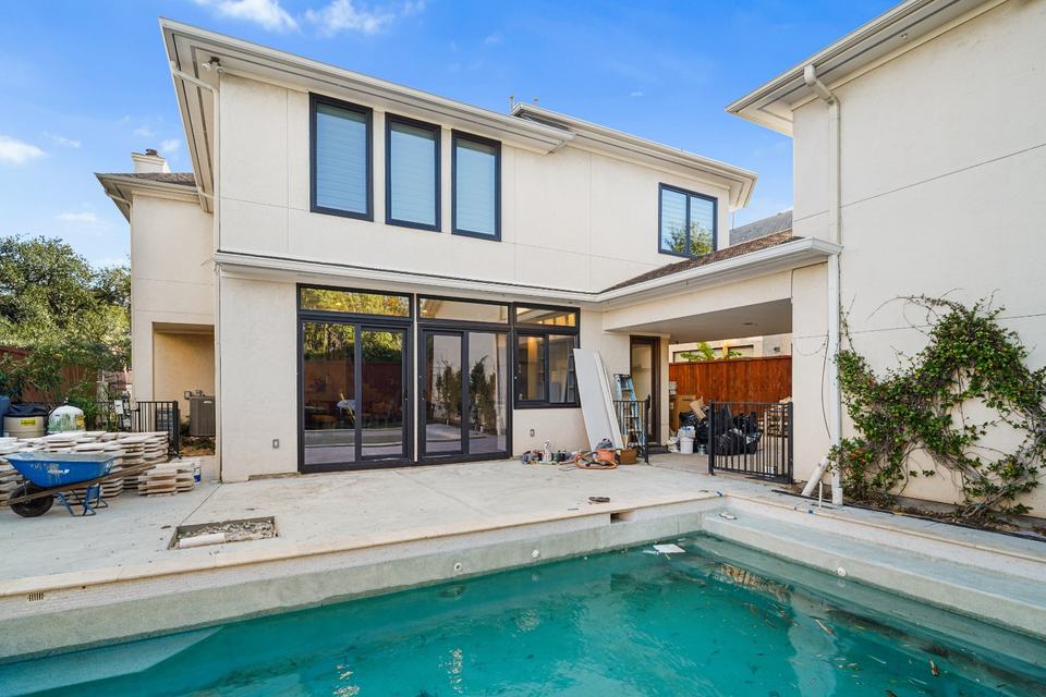 Poolside elevation with large aluminum sliding glass doors