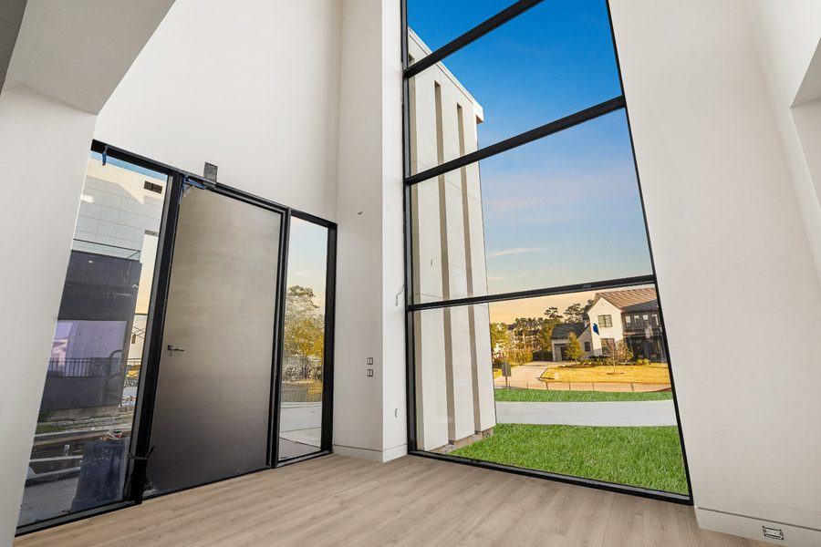 Double-height window wall beside the entry door, The Woodlands TX 77380